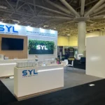 Professional exhibition booth design showcasing modern branding, interactive displays, and visitor engagement at a trade show.