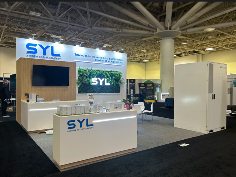 Small exhibition booth design with backlit logo, green wall display, TV screen and lit counters by exhibition stand companies in Dallas